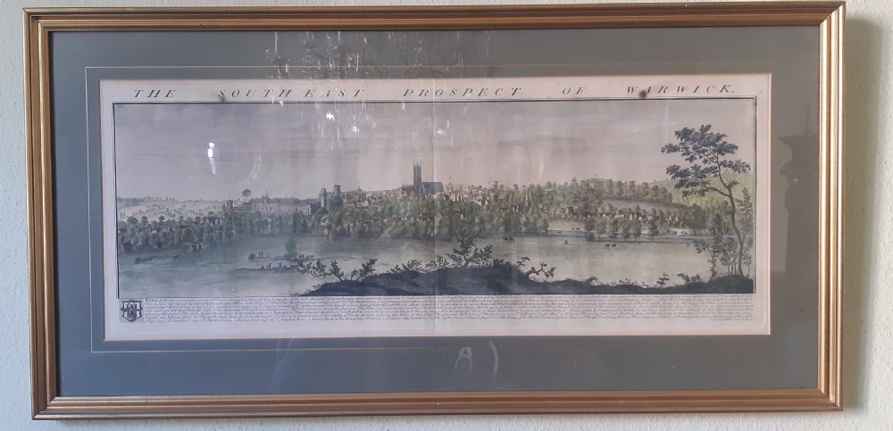 A framed panoramic 18th-century copperplate engraving showing a south-east prospect of Warwick with a grey mount and gilt frame.