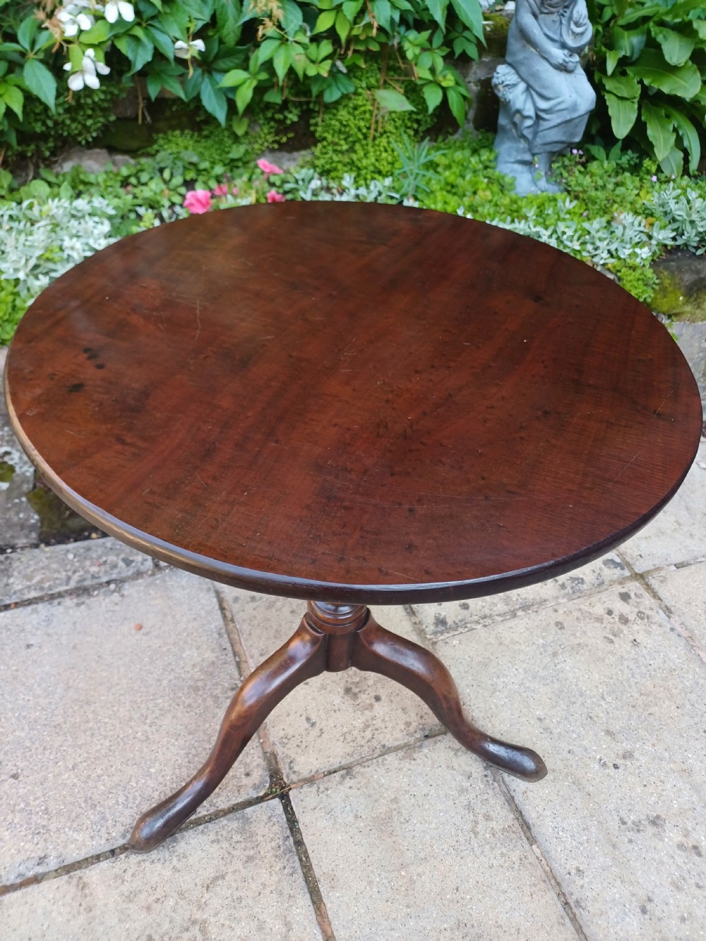 A Georgian mahogany tripod table featuring a circular top, a turned central baluster pedestal, and three splayed cabriole legs. View III