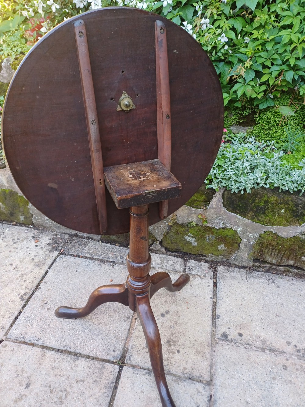 A Georgian mahogany tripod table featuring a circular top, a turned central baluster pedestal, and three splayed cabriole legs. View IV