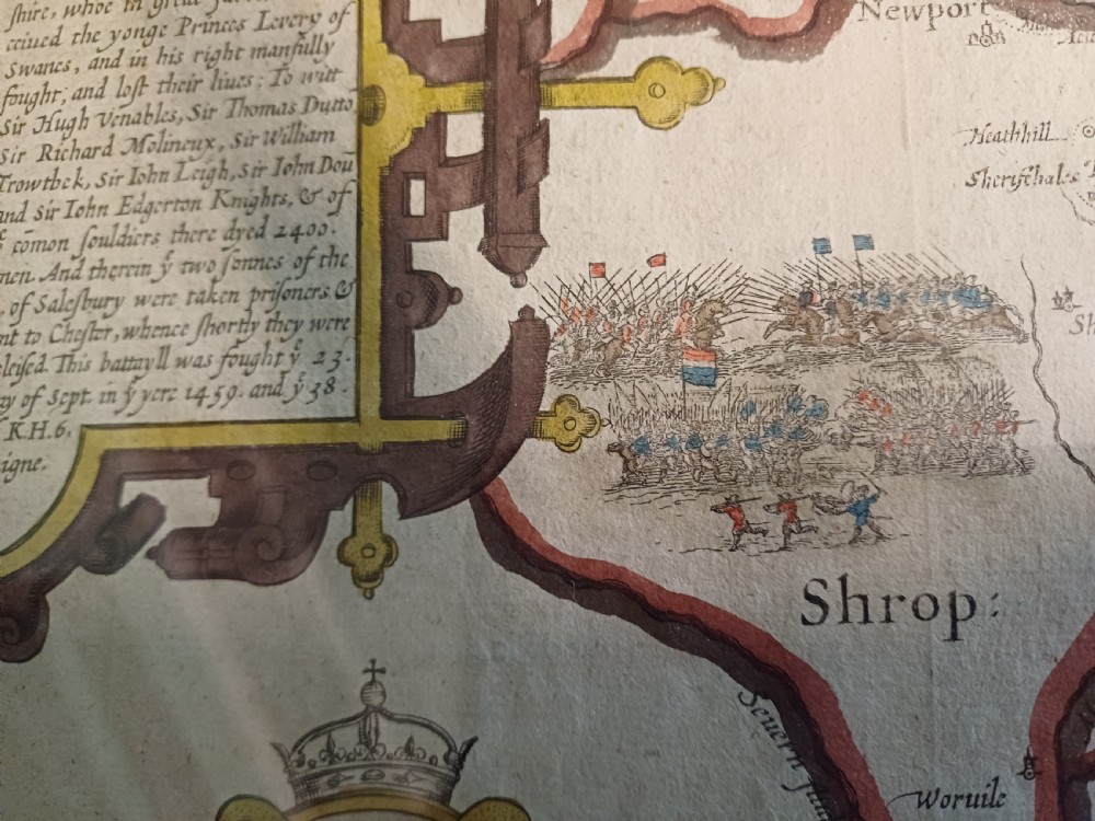 Framed 17th-century hand-coloured engraved map of Staffordshire by John Speed featuring heraldic crests and inset town plans of Stafford and Lichfield. View XII