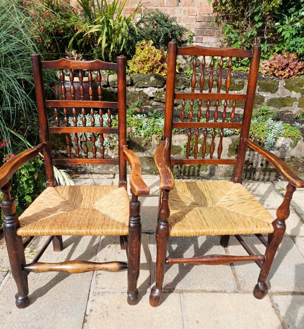 A set of six dark oak spindleback dining chairs featuring hand-woven rush seats and turned wooden legs. View VII