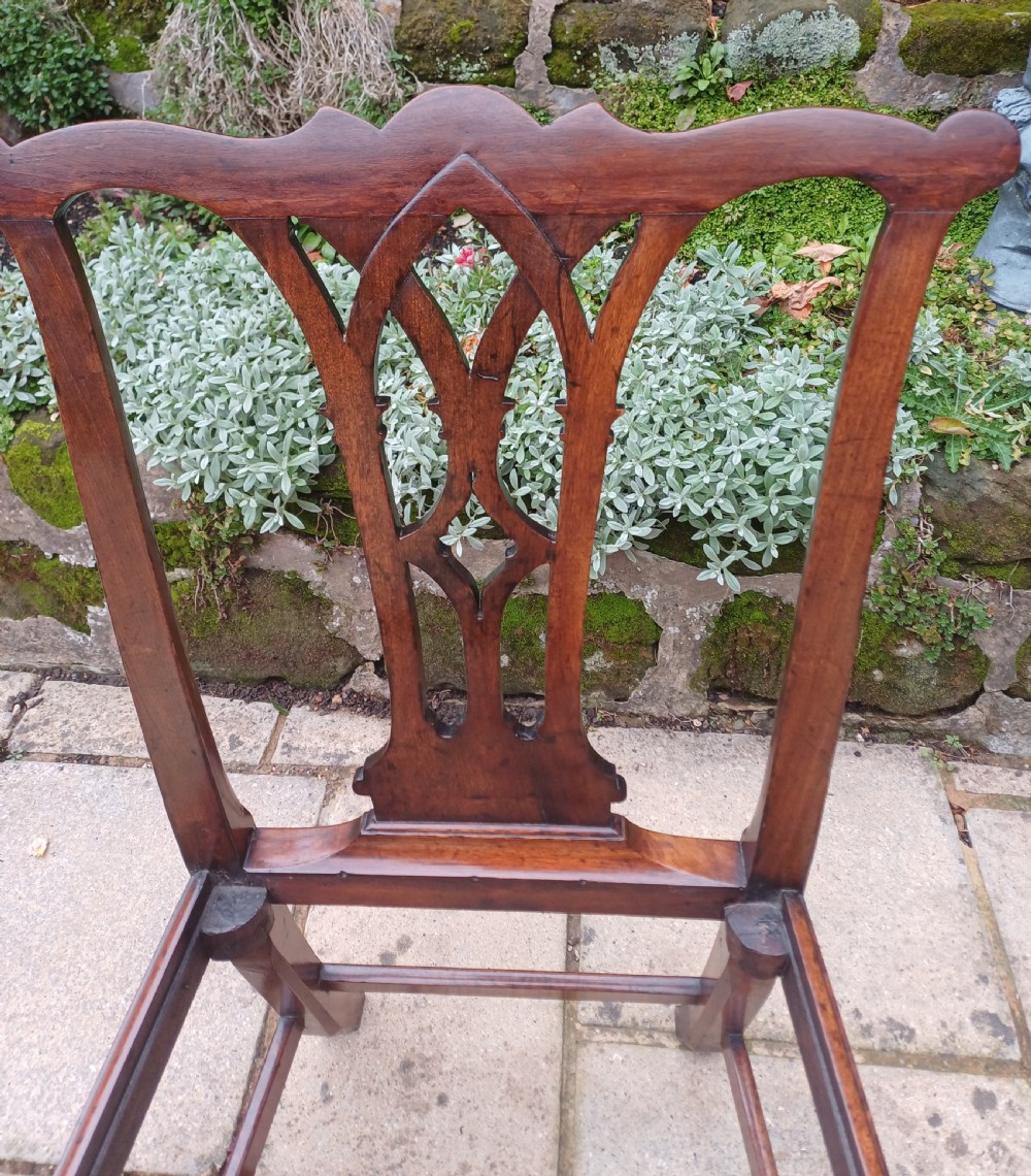An 18th-century Chippendale mahogany side chair featuring a carved Gothic pierced splat back and a neutral striped fabric seat. View IV