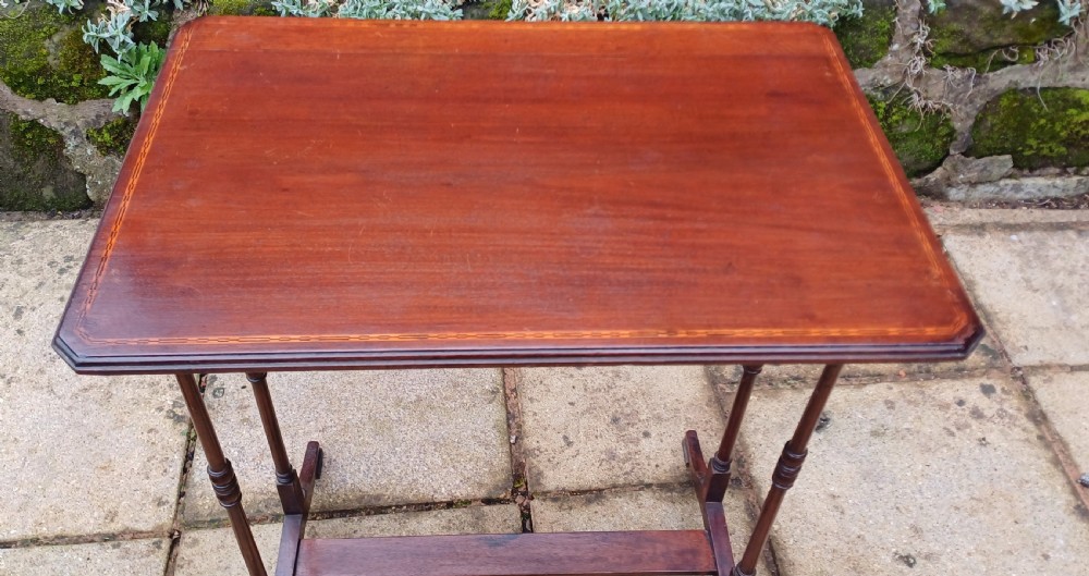 An Edwardian rectangular mahogany occasional table featuring perimeter string inlay, slender turned legs, and a low stretcher support. View VI