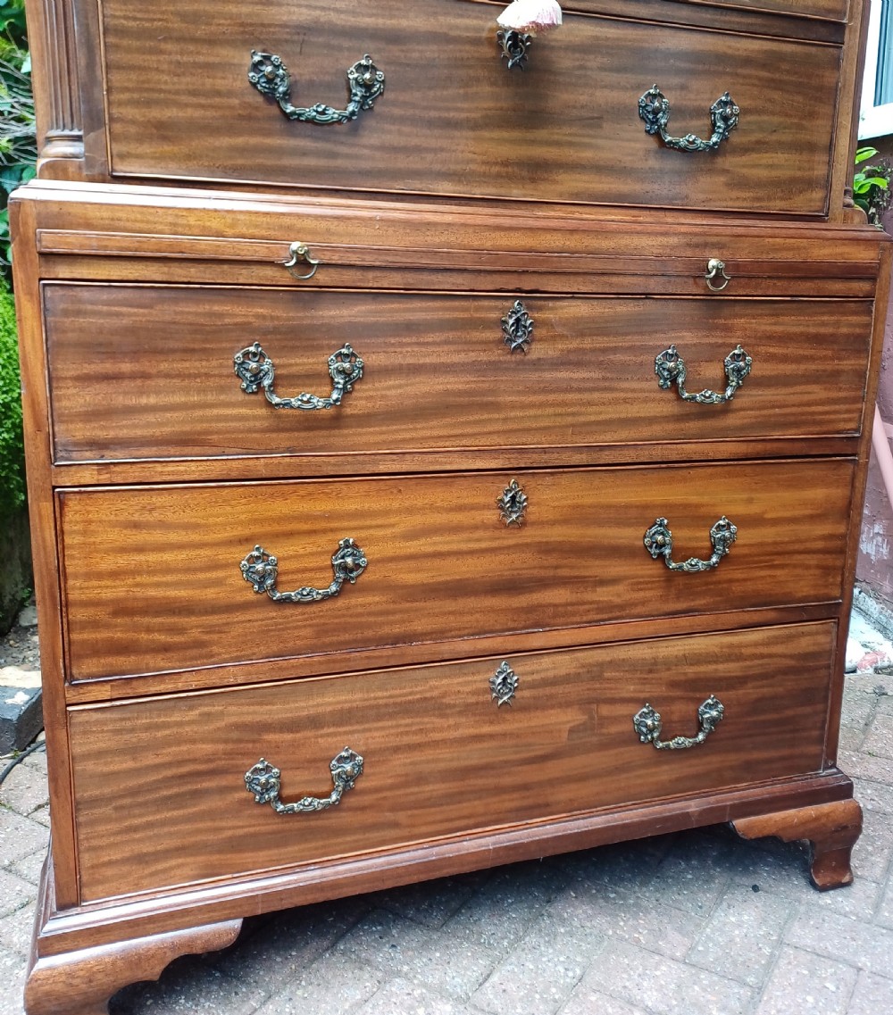An 18th-century Georgian mahogany tallboy chest on chest featuring a carved frieze, brass handles, and multiple graduated drawers. View VIII