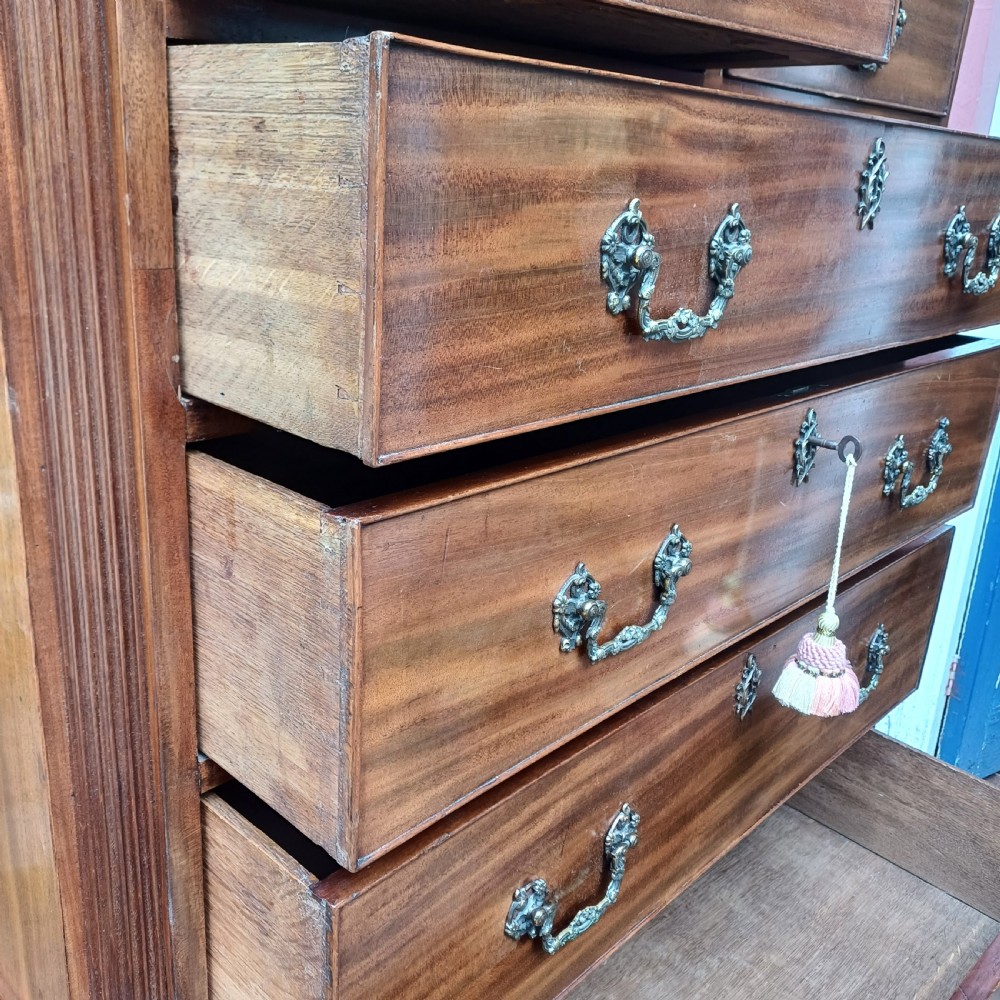 An 18th-century Georgian mahogany tallboy chest on chest featuring a carved frieze, brass handles, and multiple graduated drawers. View XI