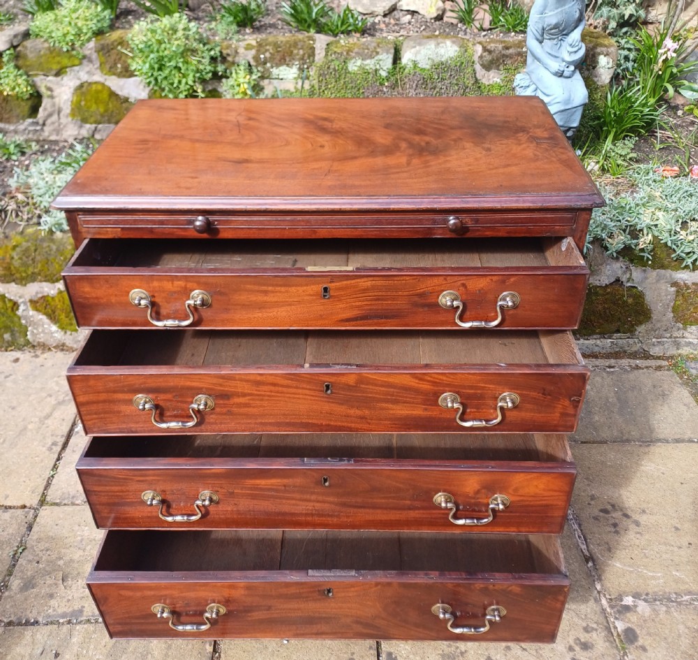 A small Georgian mahogany chest of drawers featuring four graduated drawers, brass swan-neck handles, a pull-out brushing slide, and bracket feet. View III