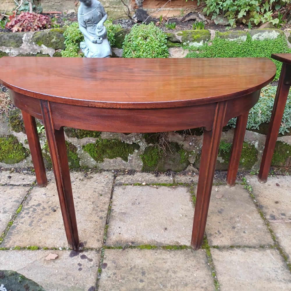A pair of Georgian mahogany demi-lune tables with semi-circular tops and straight tapered legs. View III