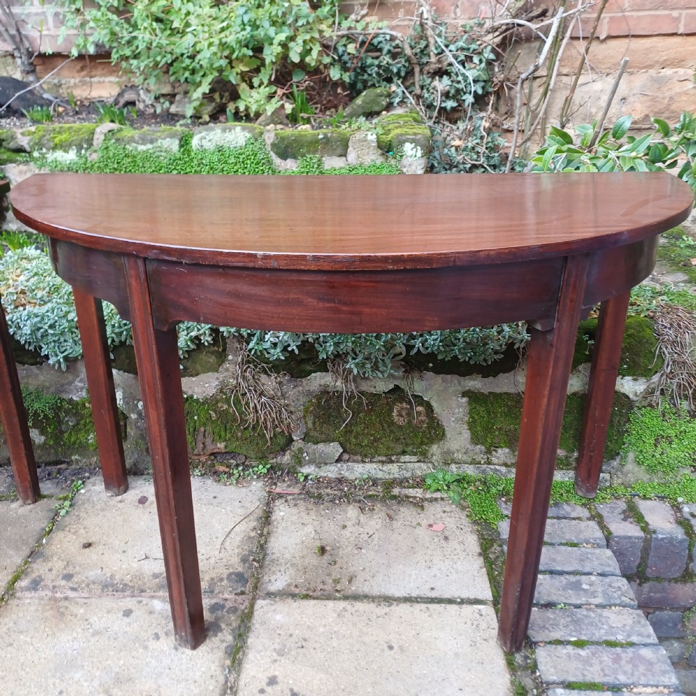 A pair of Georgian mahogany demi-lune tables with semi-circular tops and straight tapered legs. View IV