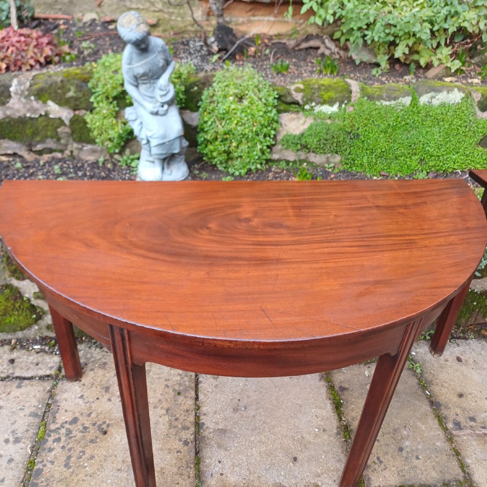A pair of Georgian mahogany demi-lune tables with semi-circular tops and straight tapered legs. View VI