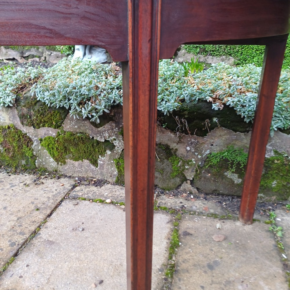 A pair of Georgian mahogany demi-lune tables with semi-circular tops and straight tapered legs. View VII