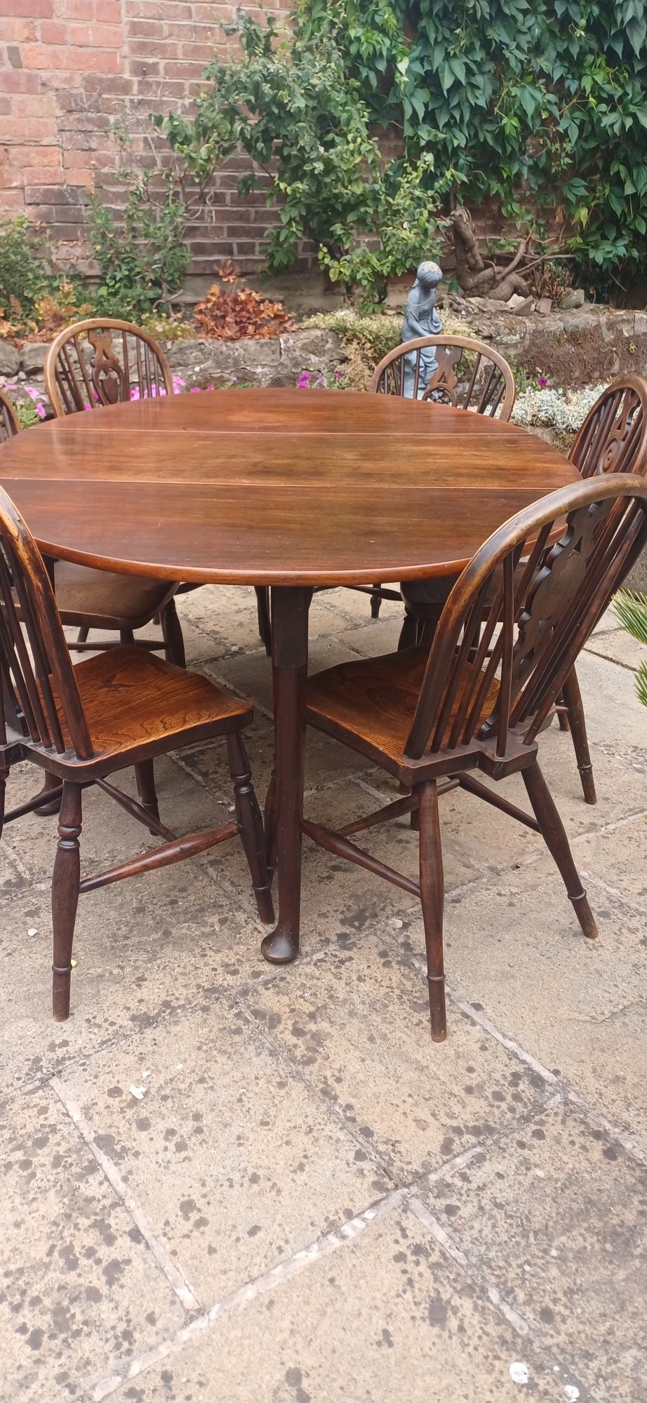 A dark mahogany Georgian drop-leaf dining table with two hinged side leaves resting on tapered legs with pad feet. View VII