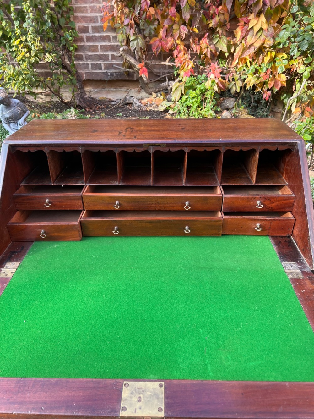 An 18th-century Georgian mahogany bureau with a slant-front writing lid above four long graduated drawers fitted with brass swan-neck handles. View III
