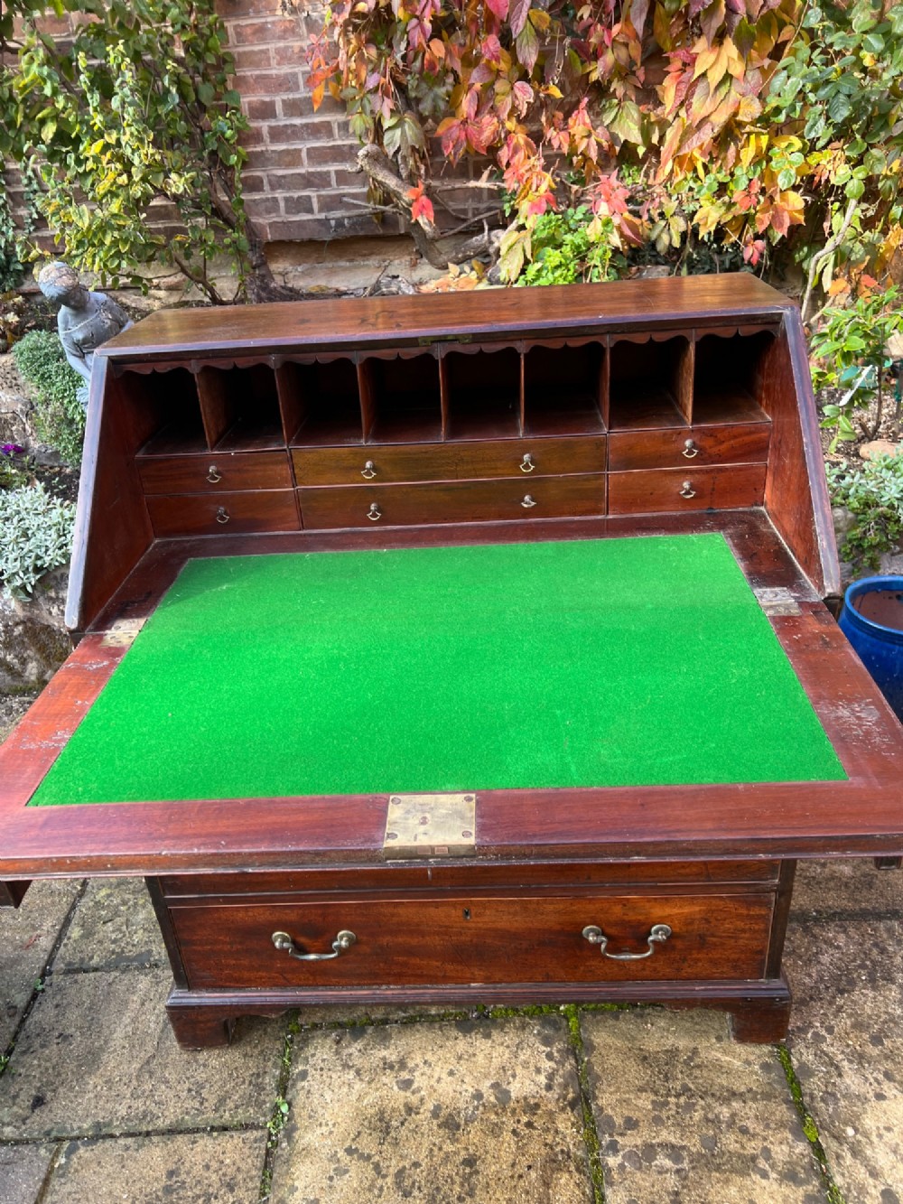 An 18th-century Georgian mahogany bureau with a slant-front writing lid above four long graduated drawers fitted with brass swan-neck handles. View IV