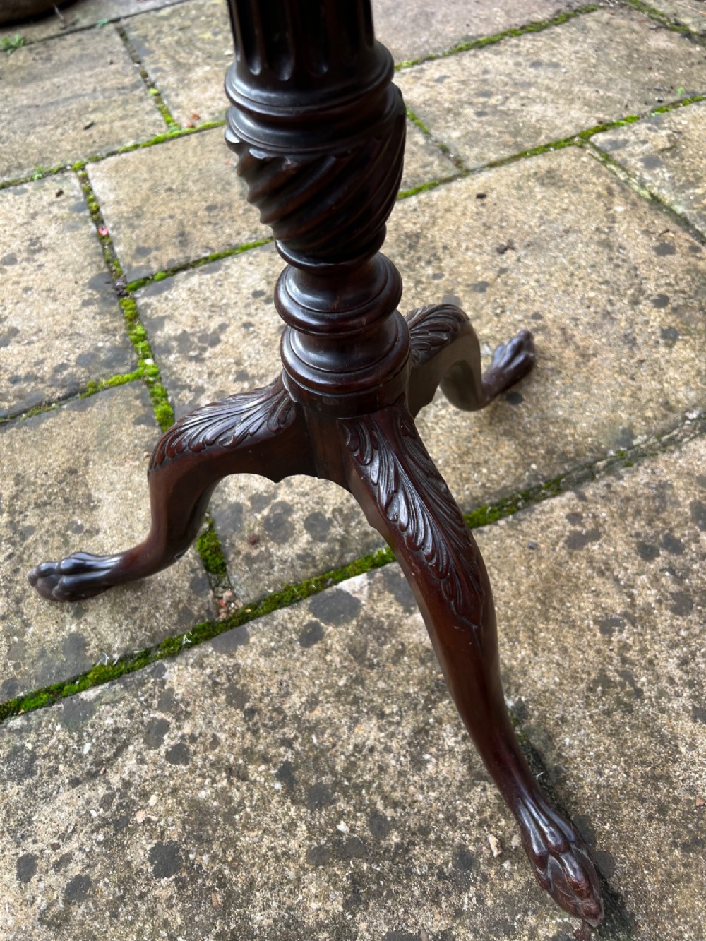 An eighteenth-century circular mahogany tripod table featuring a turned fluted column, acanthus carved cabriole legs, and claw-and-ball feet. View III