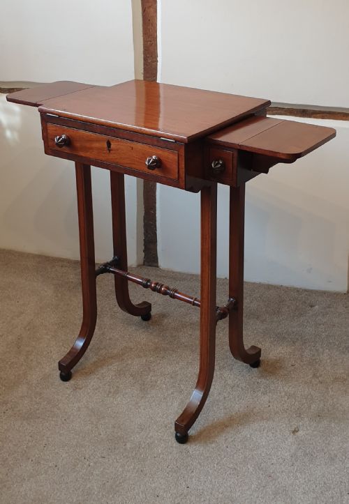 AN ANTIQUE MAHOGANY OCCASIONAL TABLE WITH ADJUSTABLE READING STAND