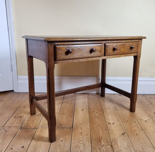 a 1920s oak twodrawer side table in the manner of the cotswold school - CATEGORY: ANTIQUE TABLES - DATED 1920