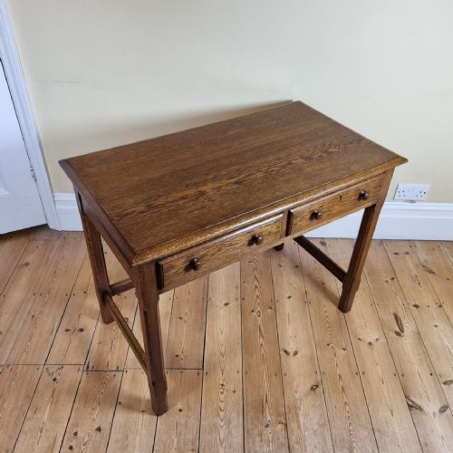 A 1920S OAK TWODRAWER SIDE TABLE IN THE MANNER OF THE COTSWOLD SCHOOL - ADDITIONAL PHOTO 2