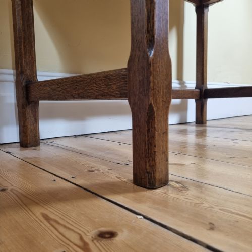 A 1920S OAK TWODRAWER SIDE TABLE IN THE MANNER OF THE COTSWOLD SCHOOL - ADDITIONAL PHOTO 1