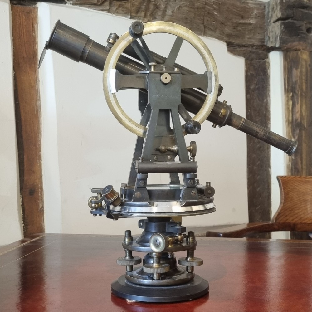 A 19th-century patinated brass vernier theodolite featuring a mounted optical telescope, spirit level, and calibrated circular scale.