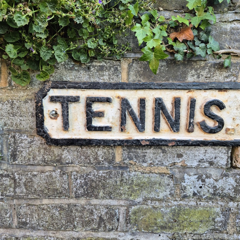 A rectangular 1920s cast iron street sign featuring embossed black lettering spelling TENNIS WALK on a weathered off-white background with a black border. View IV