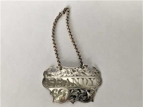 fig 1. A Victorian silver escutcheon Brandy decanter label