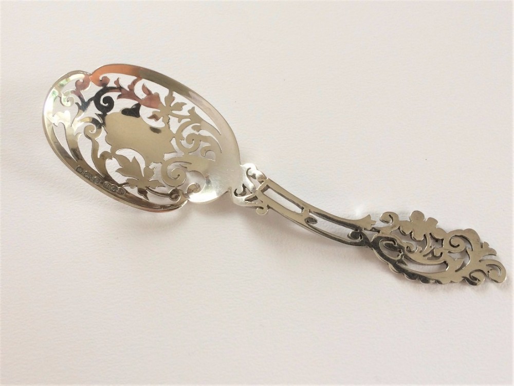 A fabulous pierced Edwardian silver caddy or bonbon spoon.