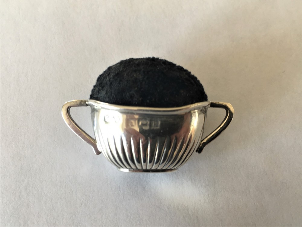 A  novelty Edwardian silver pin cushion