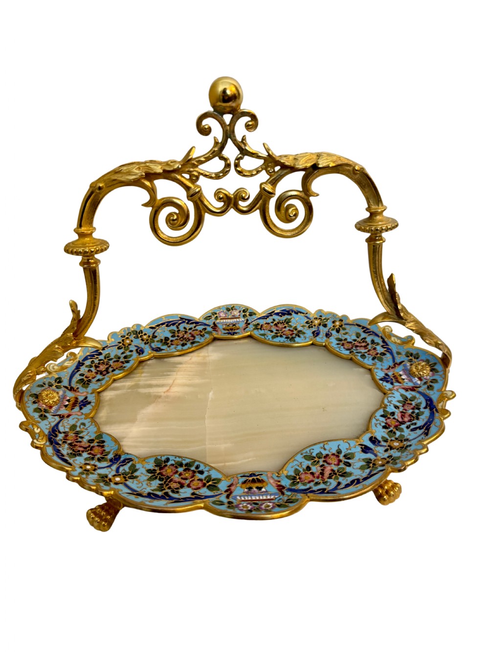 An antique French centrepiece tray featuring an oval pale onyx surface surrounded by a floral blue champleve enamel border and a gilt ormolu scroll handle.