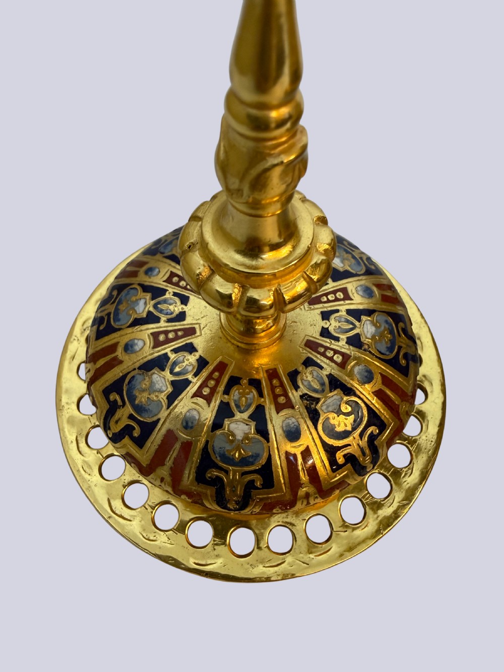 A 19th-century French lidded urn crafted from gilt bronze featuring blue and red champleve enamel detailing with figural handles and a finial lid. View VI