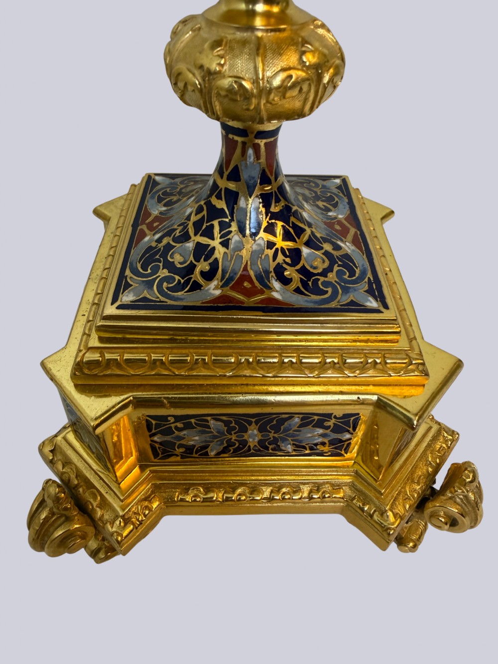 A 19th-century French lidded urn crafted from gilt bronze featuring blue and red champleve enamel detailing with figural handles and a finial lid. View VII