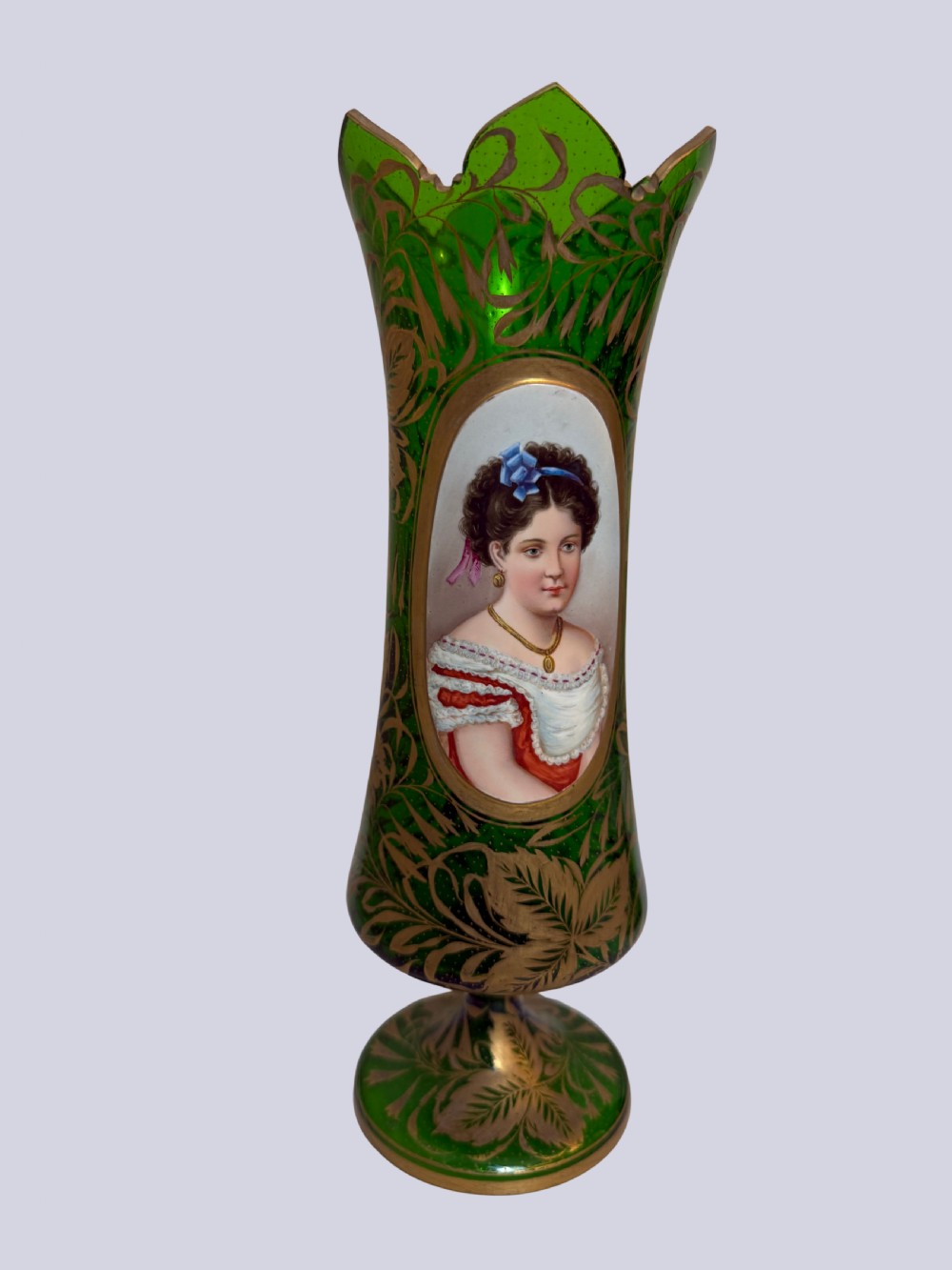 A three-piece emerald green Bohemian glass garniture set featuring gold gilt leaf patterns and oval enamel painted lady portraits. View II