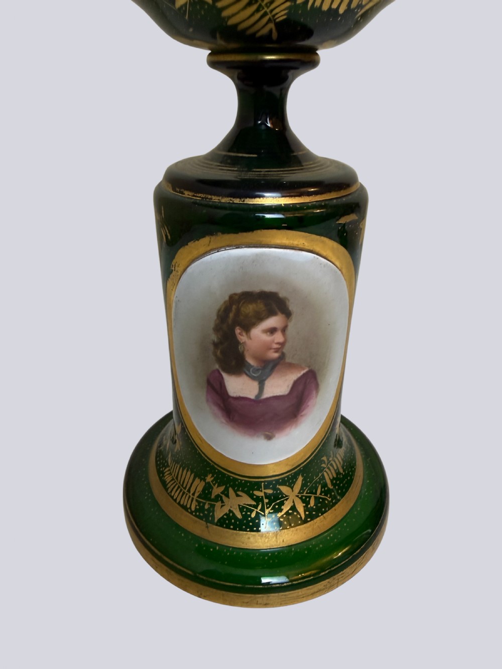 A three-piece emerald green Bohemian glass garniture set featuring gold gilt leaf patterns and oval enamel painted lady portraits. View V