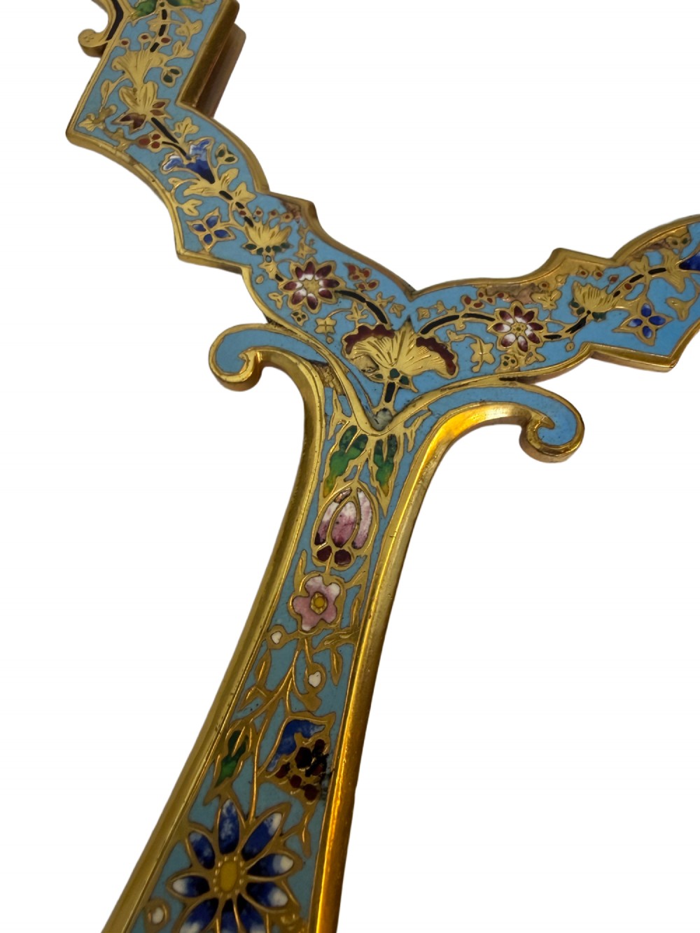 A 19th-century French gilt bronze and champleve enamel picture frame resting alongside a matching hand mirror with colourful floral motifs. View II