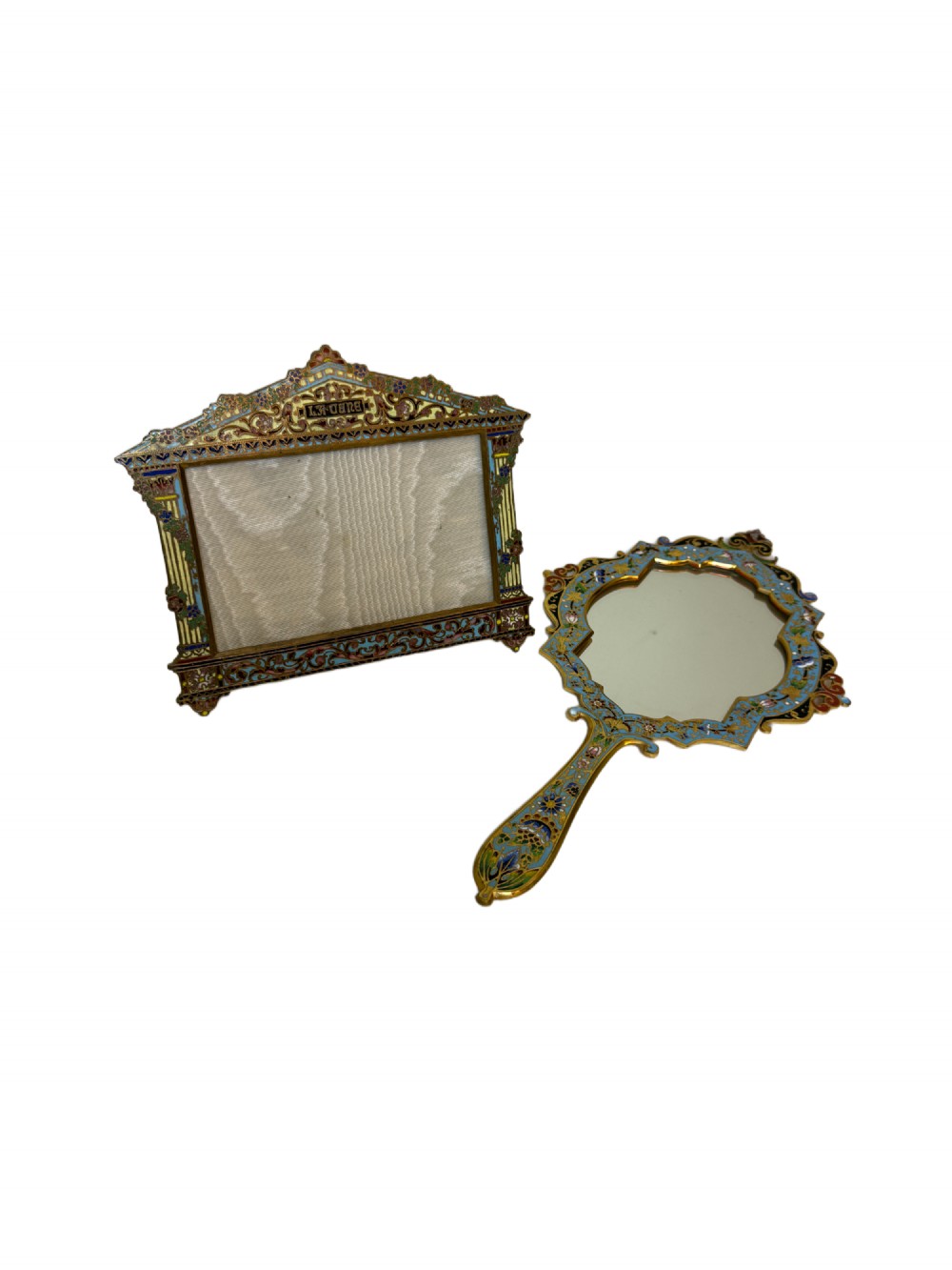 A 19th-century French gilt bronze and champleve enamel picture frame resting alongside a matching hand mirror with colourful floral motifs. View VII