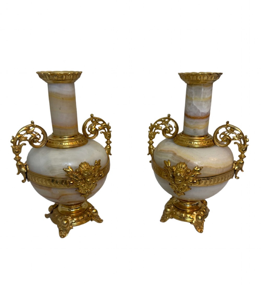 A pair of 19th-century French vases constructed from cream white veined onyx with ornate gilt bronze handles, winged cherub mounts, and footed bases. View II