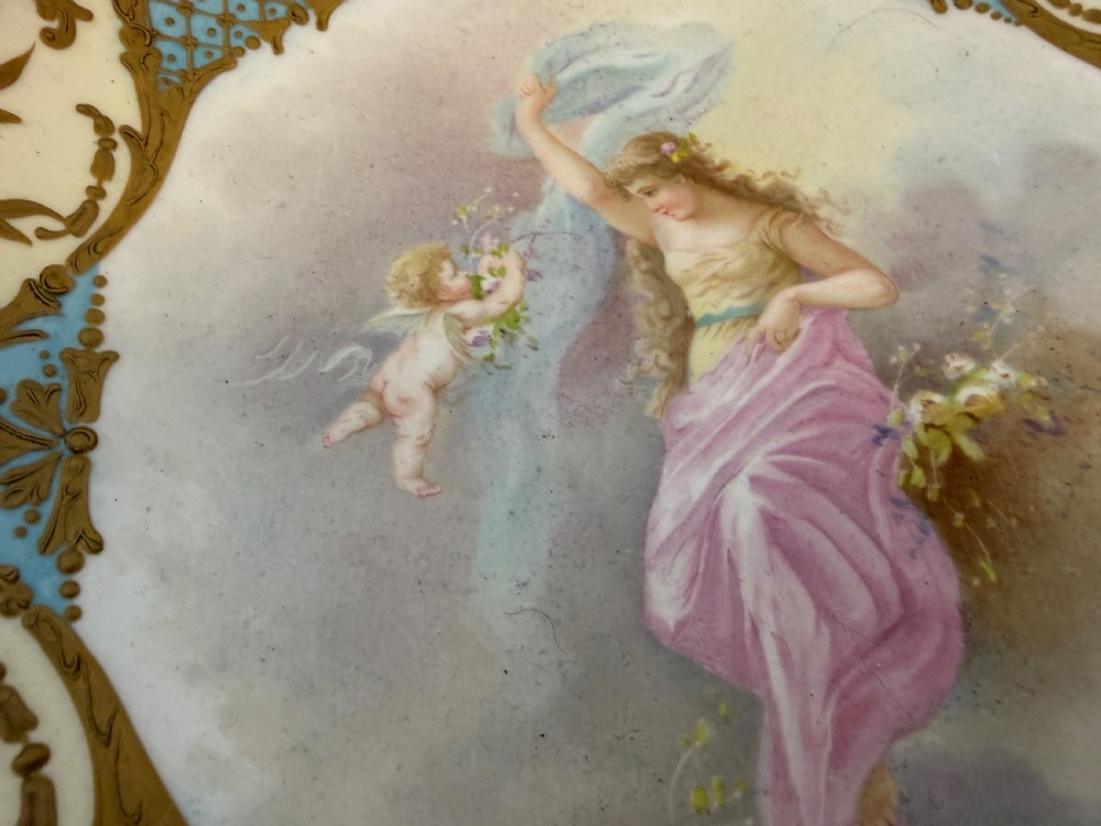 A circular 19th-century French porcelain centrepiece with hand-painted classical figures framed by colourful champleve enamel and twin gilt bronze handles. View III