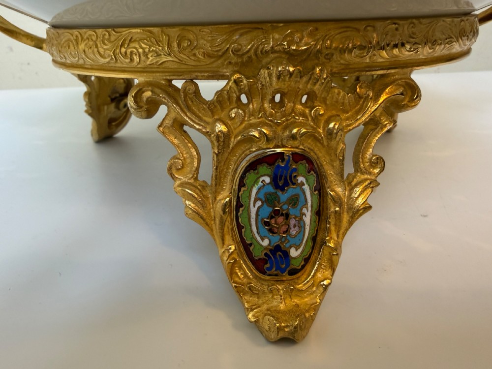 A circular 19th-century French porcelain centrepiece with hand-painted classical figures framed by colourful champleve enamel and twin gilt bronze handles. View VI