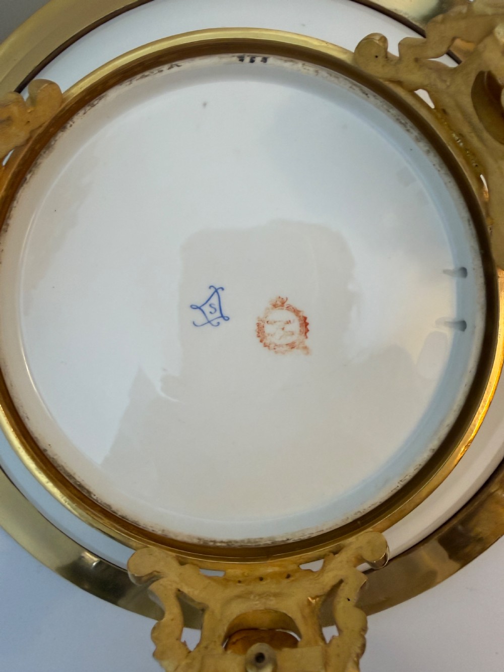 A circular 19th-century French porcelain centrepiece with hand-painted classical figures framed by colourful champleve enamel and twin gilt bronze handles. View IX
