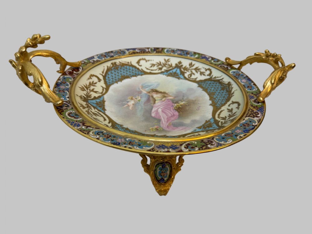 A circular 19th-century French porcelain centrepiece with hand-painted classical figures framed by colourful champleve enamel and twin gilt bronze handles. View XI