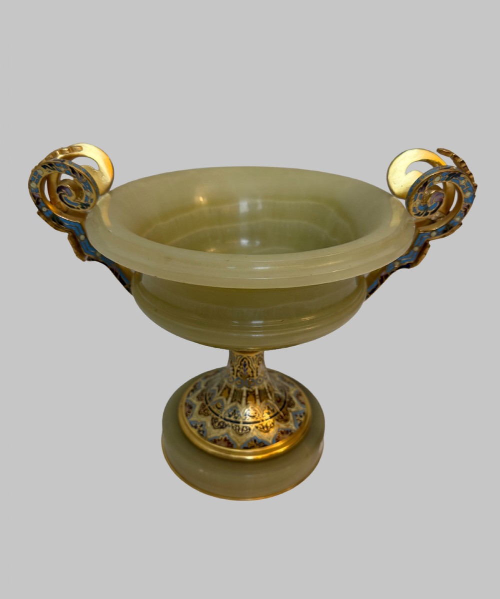 A 19th-century French green onyx centrepiece bowl on a pedestal base featuring twin scroll handles decorated with champleve enamel and gilt bronze mounts.