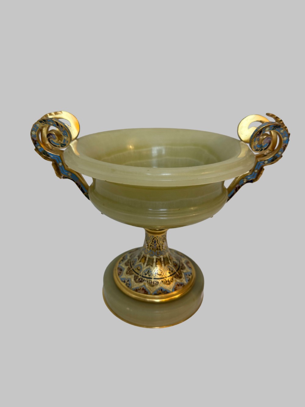 A 19th-century French green onyx centrepiece bowl on a pedestal base featuring twin scroll handles decorated with champleve enamel and gilt bronze mounts. View VII