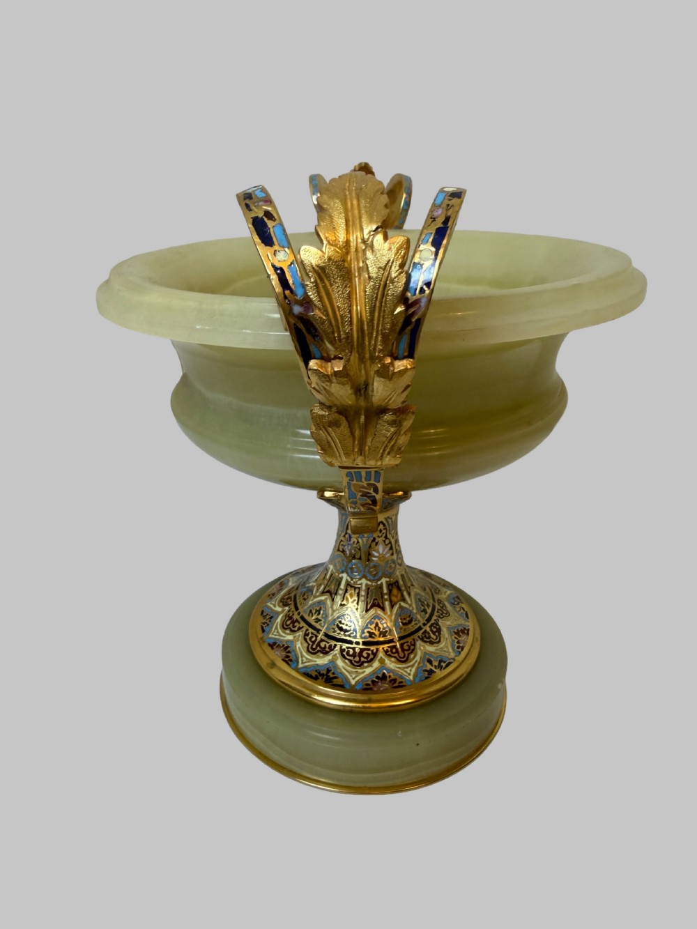 A 19th-century French green onyx centrepiece bowl on a pedestal base featuring twin scroll handles decorated with champleve enamel and gilt bronze mounts. View VIII