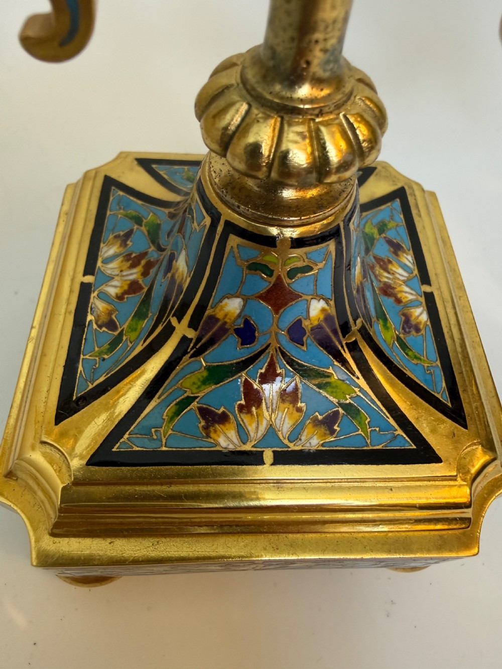 A pair of 19th-century gilt bronze two-light candelabra decorated with blue and multicoloured champleve enamel on square stepped bases. View III