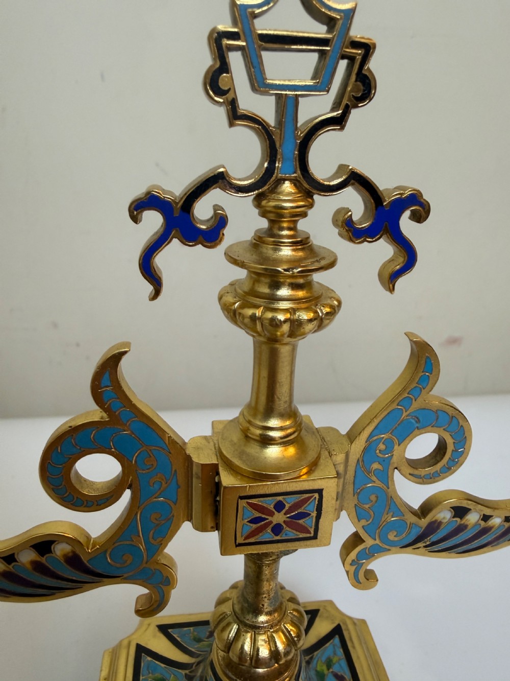 A pair of 19th-century gilt bronze two-light candelabra decorated with blue and multicoloured champleve enamel on square stepped bases. View IV