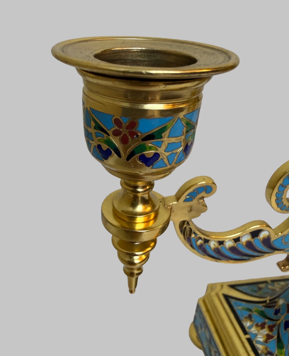 A pair of 19th-century gilt bronze two-light candelabra decorated with blue and multicoloured champleve enamel on square stepped bases. View V