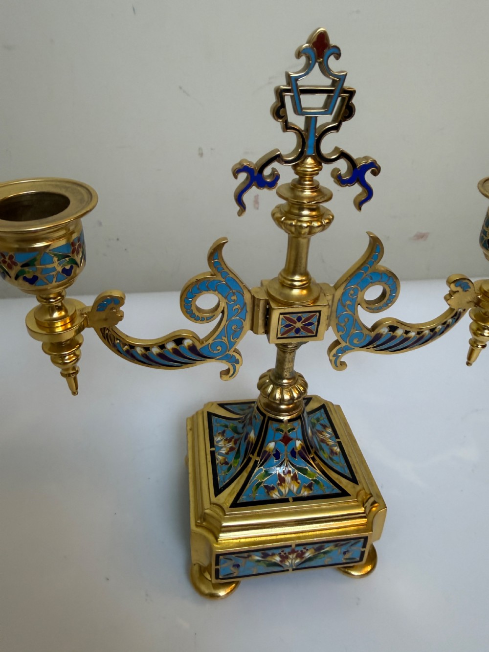 A pair of 19th-century gilt bronze two-light candelabra decorated with blue and multicoloured champleve enamel on square stepped bases. View VI