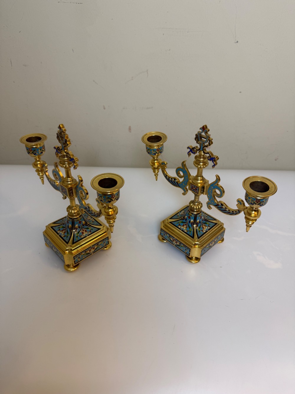 A pair of 19th-century gilt bronze two-light candelabra decorated with blue and multicoloured champleve enamel on square stepped bases. View VII