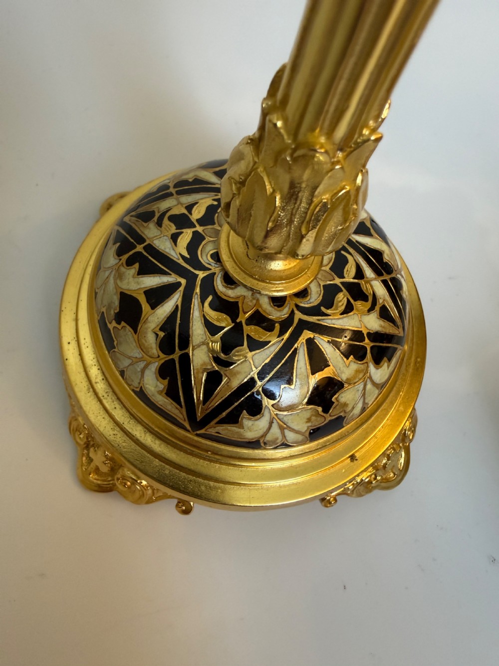 A nineteenth-century French writing set featuring a covered central inkwell flanked by two matching gilt bronze and champleve enamel candlesticks. View II