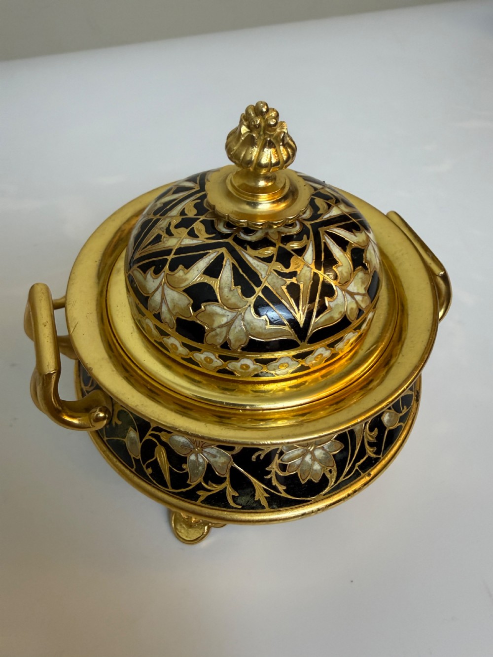 A nineteenth-century French writing set featuring a covered central inkwell flanked by two matching gilt bronze and champleve enamel candlesticks. View IV