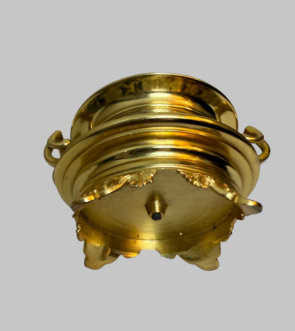 A nineteenth-century French writing set featuring a covered central inkwell flanked by two matching gilt bronze and champleve enamel candlesticks. View VI
